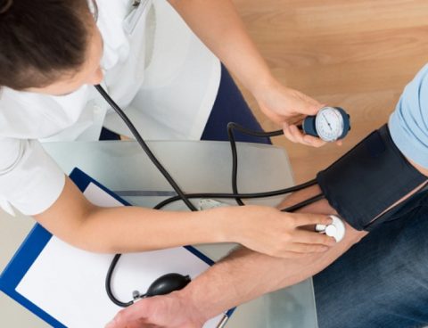 Nurse checking blood pressure of Veitchi employee in health check